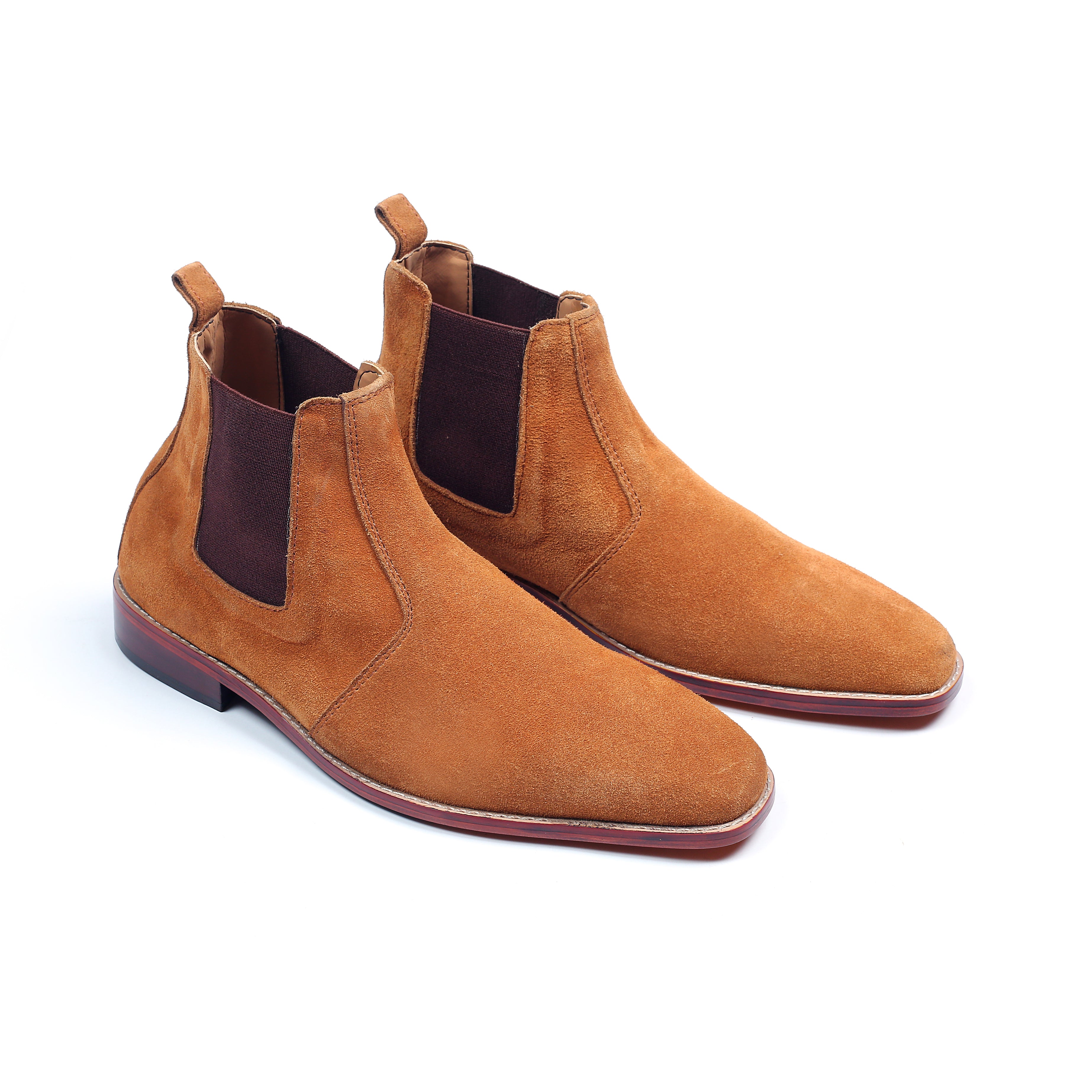 Pair of brown suede Chelsea boots on a white background