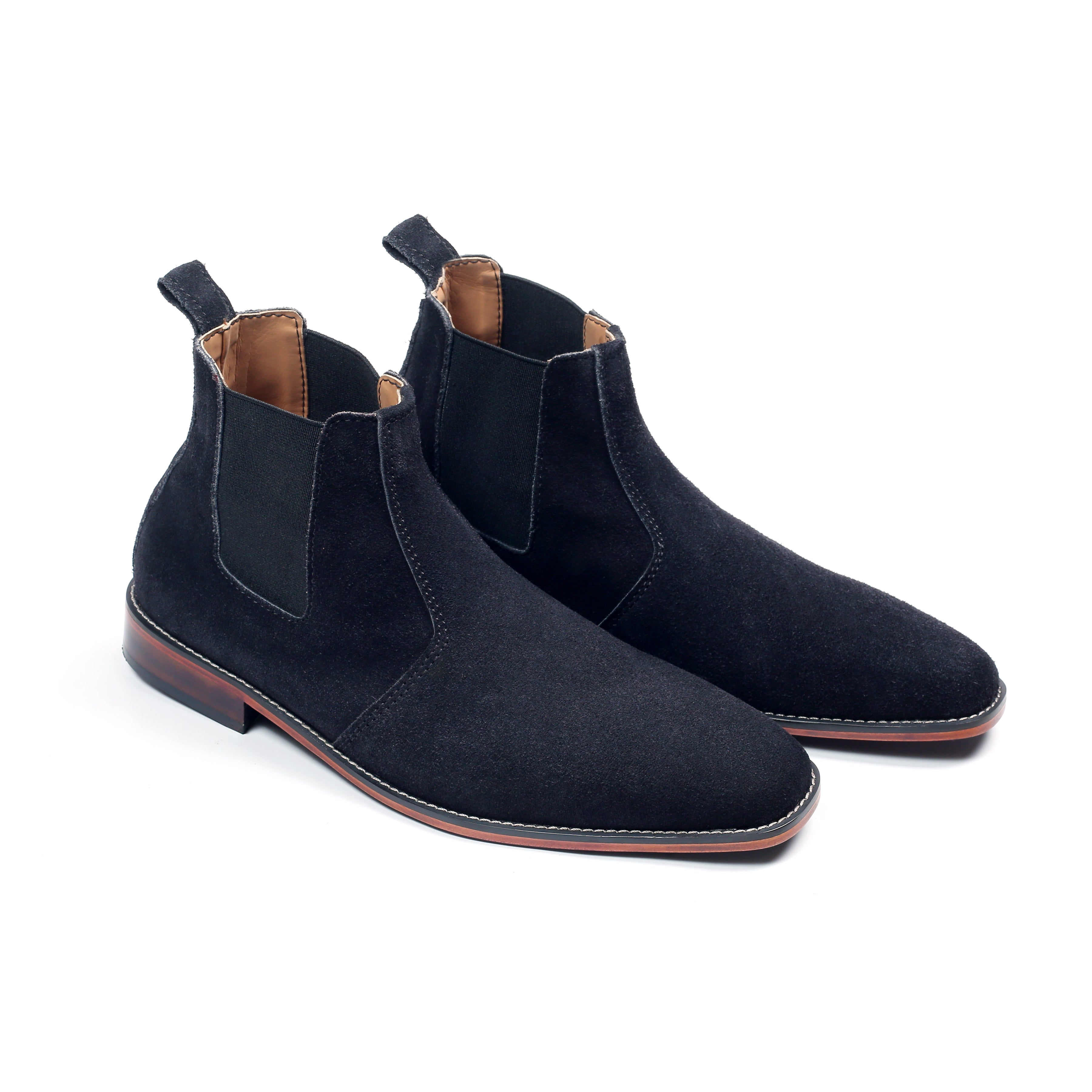 Pair of black suede Chelsea boots on a white background
