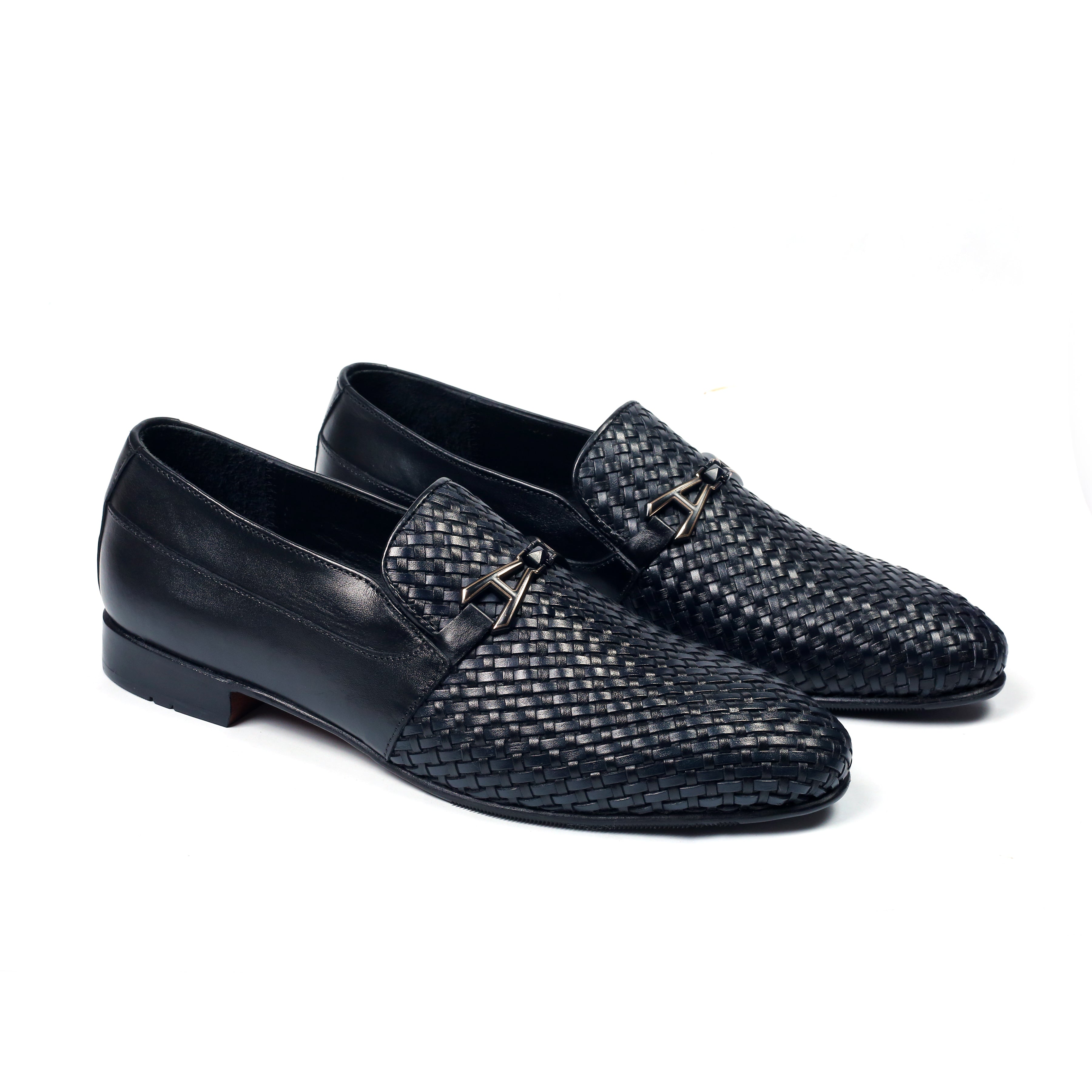 A pair of black leather lace-up flats with a textured design on a white background