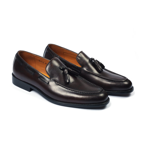 A pair of brown, lace-up, leather formal shoes with a metal accent on the toe.