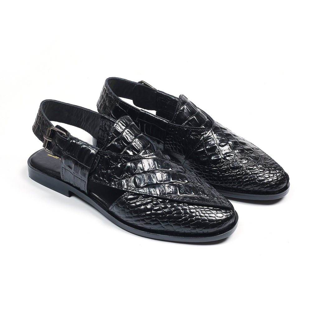 Black crocodile-patterned shoes on a white background