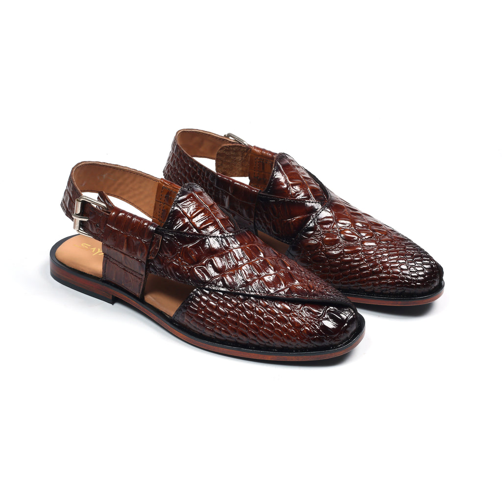 Brown crocodile-patterned shoes on a white background